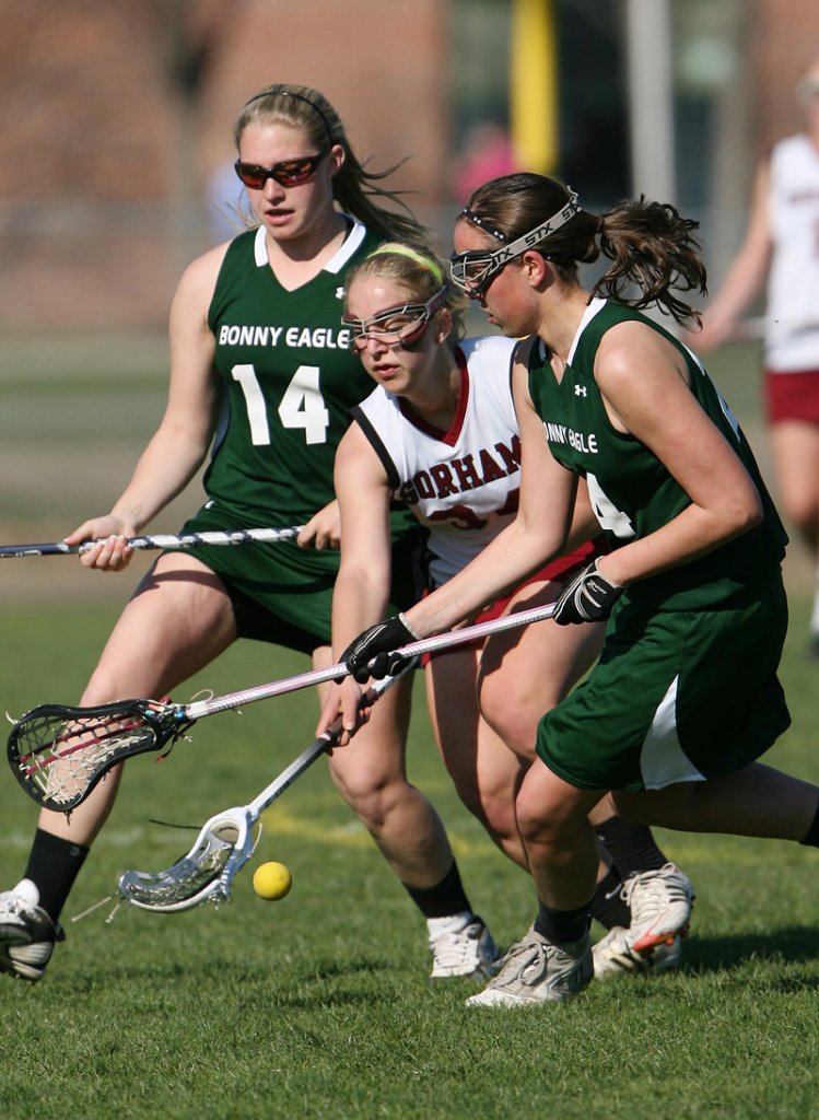 Emily Lewis of Gorham, center, competes for the ball with Sam Campobasso, left, and Shannon Sanborn of Bonny Eagle during Gorham’s 12-5 victory Tuesday in a schoolgirl lacrosse game at Gorham.