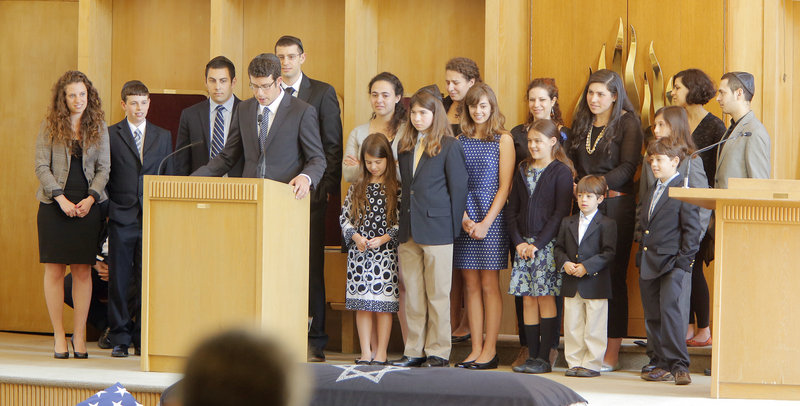 The grandchildren of Albert Glickman gather around the podium and tell stories of their grandfather at his funeral service at Temple Beth El in Portland on Wednesday, May 1, 2013. Glickman was a noted philanthropist who was known for his deep love of his family.