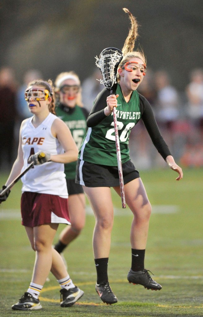Cat Johnson of Waynflete reacts Wednesday night after scoring in the 10-8 victory against Cape Elizabeth in a game between unbeaten girls’ lacrosse teams.