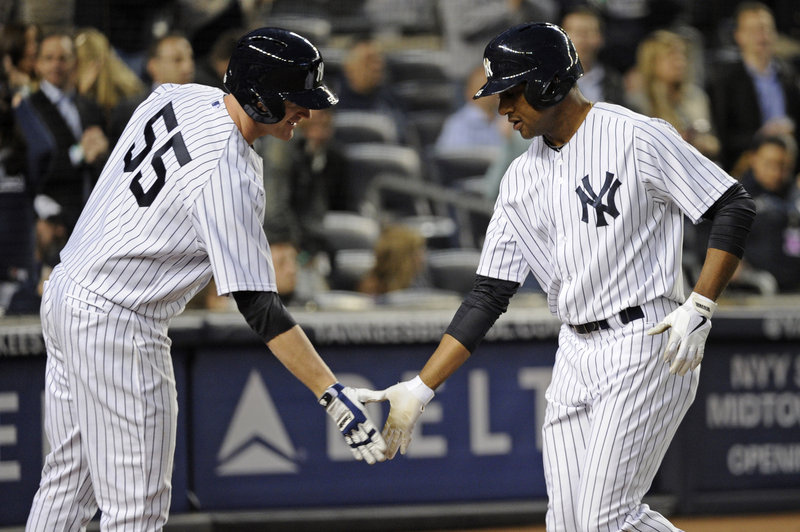 The Yankees’ Ben Francisco, right, is greeted by Lyle Overbay after Francisco homered in the third inning of New York’s 5-4 win over the Houston Astros at New York on Wednesday.