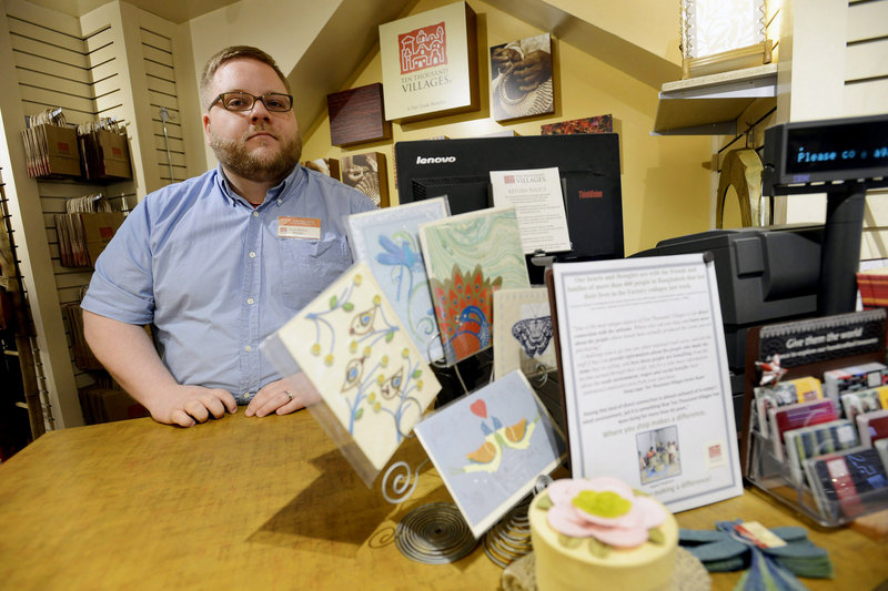Kevin Hudson, store manager at Ten Thousand Villages on Exchange Street in Portland, sits near merchandise on display from Bangladesh along with a sign stating their support for family and friends of the victims of the factory collapse. Photographed on Thursday, May 2, 2013. The store is encouraging Fair Trade Retail and offering their support to Bangladesh in light of the recent factory collapse.