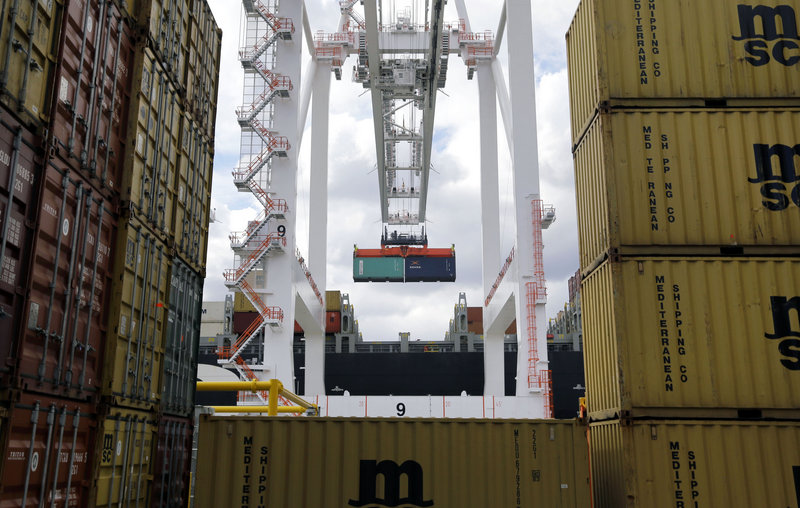 A crane removes a container from a ship at the Port of Baltimore’s Seagirt Marine Terminal in March. The U.S. trade deficit narrowed in March for a second month.