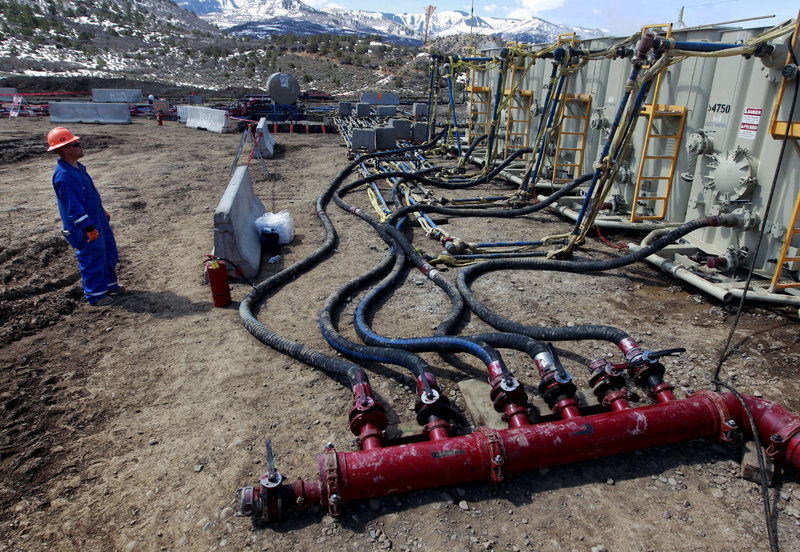 A worker monitors water pumping pressure and temperature at a hydraulic fracturing and extraction site in western Colorado. Hydraulic fracturing is the practice of injecting water, sand and chemicals to help access oil and gas deposits.