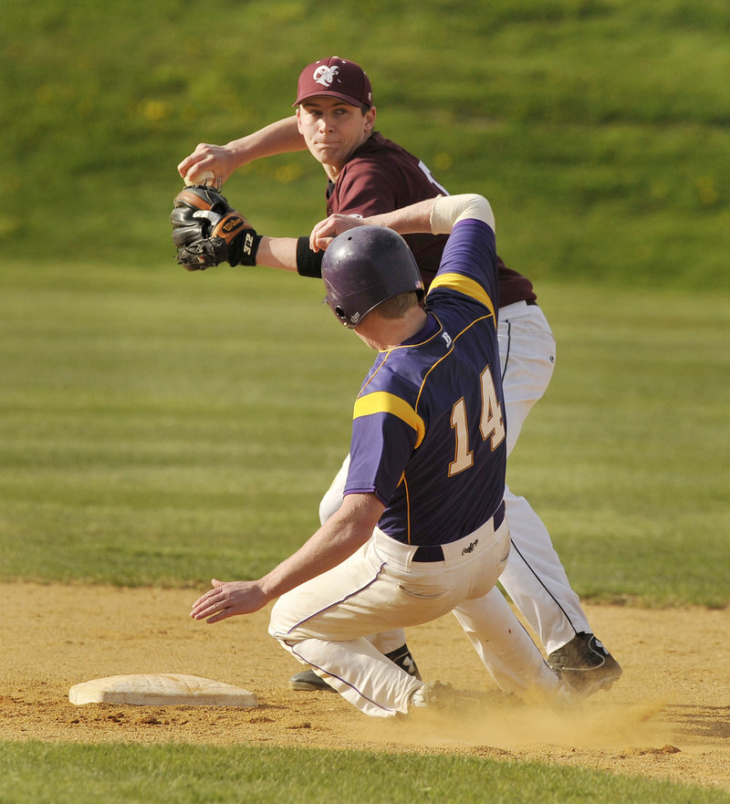 Second baseman Alex Yankowsky of Gorham attempts to turn a double play Thursday after forcing Liam Fitzpatrick of Cheverus during their SMAA baseball game. The runner was safe at first. Gorham won, 4-1.