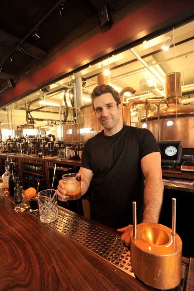 Dave Thompson, a bartender at In’finiti Fermentation & Distillation, prepares a Haute Fashioned, the bar’s variation on a traditional Old Fashioned.
