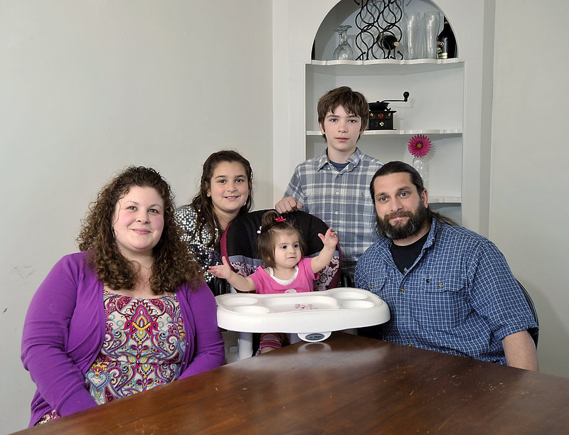 The Evans family, from left, Rosemarie, Mckenzie, Willow, Donnie and Donald, sit in the dining room of their home in Searsport late last month. In August 2011, the whole family was traveling to a remote village in Alaska when their plane went down. They broke bones and sustained significant injuries, but they survived. Last year, the Evanses moved to this Waldo County town, "a quiet place, a healing place," to recover and reconnect with life.