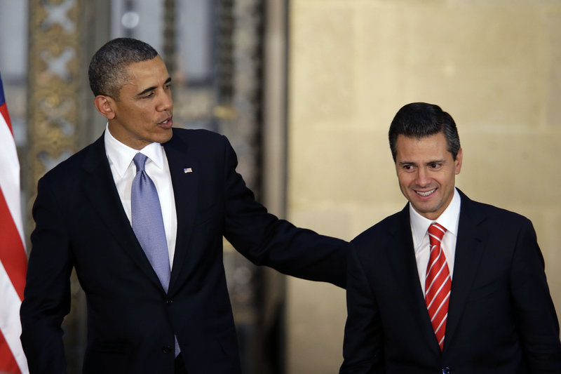 President Obama and Mexico’s President Enrique Pena Nieto leave a joint news conference in Mexico City, Mexico, on Thursday. Obama is promoting jobs and trade – not drug wars or border security – as the driving force behind the U.S.-Mexico relationship.