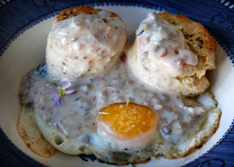 Biscuits are served with gravy and a poached egg at Squirl Cafe in Los Angeles.