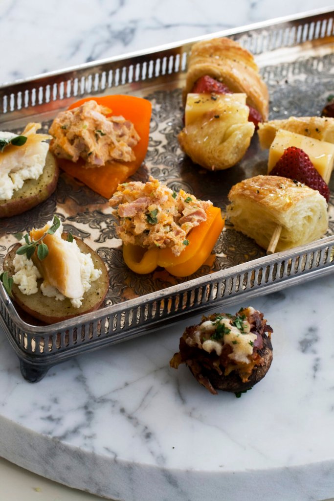 A tapas-style Mother’s Day brunch might feature smoked schmeared potatoes, left, stuffed baby bell peppers, strawberry croissant skewers and chorizo hash-stuffed mushroom caps.