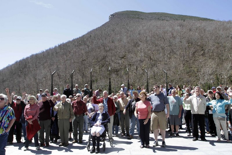 Hundreds of people gather at a park below where the Old Man of the Mountain was once seen, Friday, May 3, 2013 in Franconia, N.H. during a ceremony for the 10th anniversary of the date the natural rock formation and state emblem crashed to the ground. (AP Photo/Jim Cole)