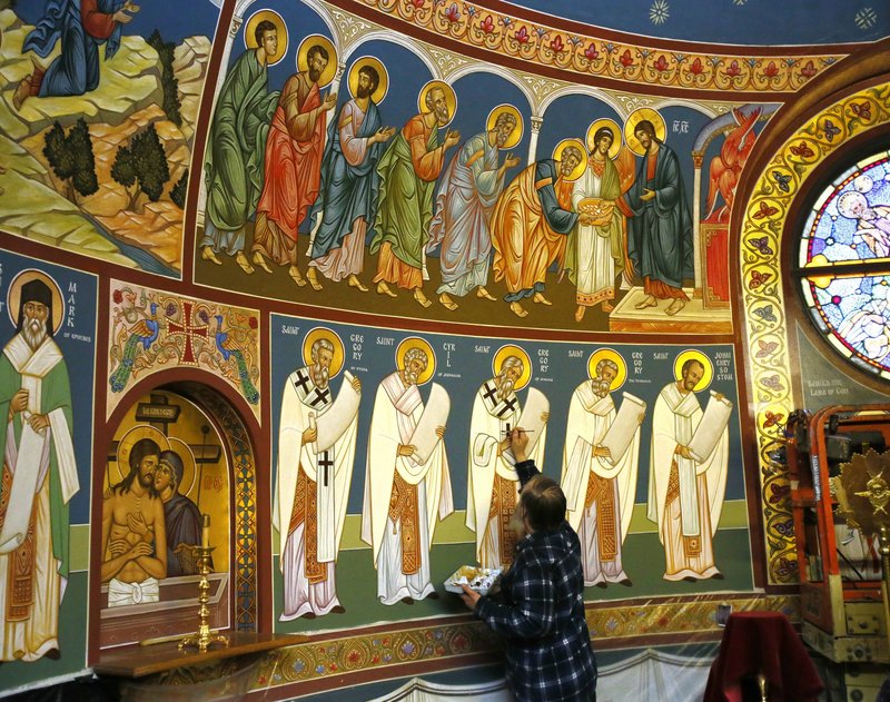 The Rev. Theodore Jurewicz, an iconographer, paints in the sacristy of St. Stephen Serbian Orthodox Church in Lackawanna, N.Y., where he has been working over the last six years to cover the interior of the church with depictions of biblical figures and events.