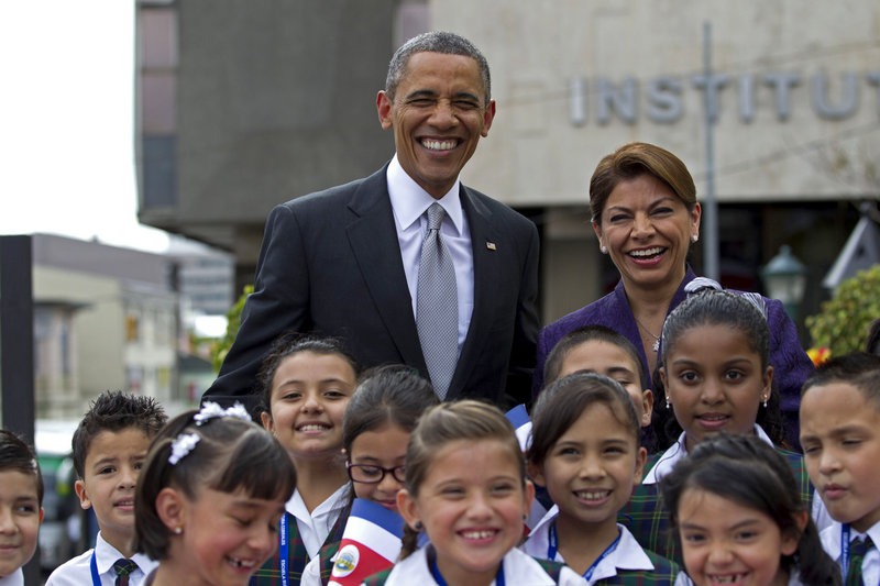 President Obama and Costa Rican President Laura Chinchilla pose for photos with a group of students upon his arrival at the foreign ministry in San Jose on Friday.