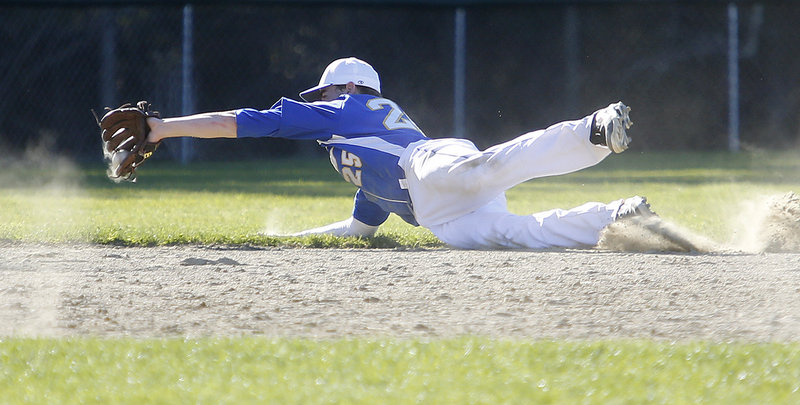 Will D’Agostino of Falmouth makes a diving stop on a grounder Friday during the fifth inning of the 5-1 loss to Greely. It was the first loss of the season for the Yachtsmen, the defending Class B state champions.