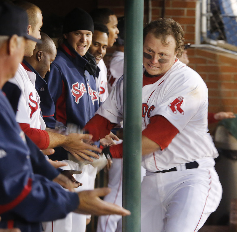 Portland’s Matt Spring gets the glad hands in the dugout after hitting a two-run homer in the seventh inning during the Sea Dogs’ 5-4 win over New Britain at Hadlock on Friday.