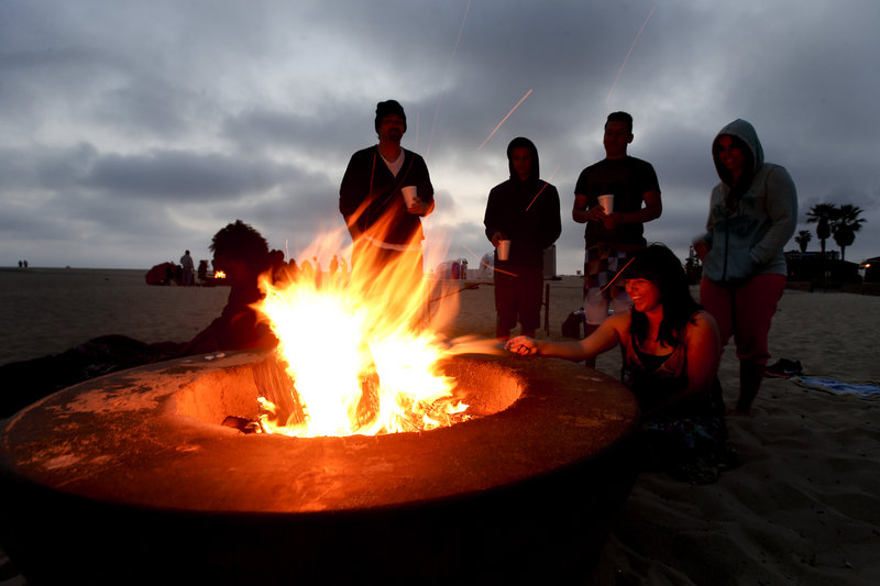Blazing fire pits like this one on Huntington Beach, Calif., have ignited controversy over their possible contribution to air pollution. Air quality regulators are considering a proposal to ban beach bonfires in Southern California.