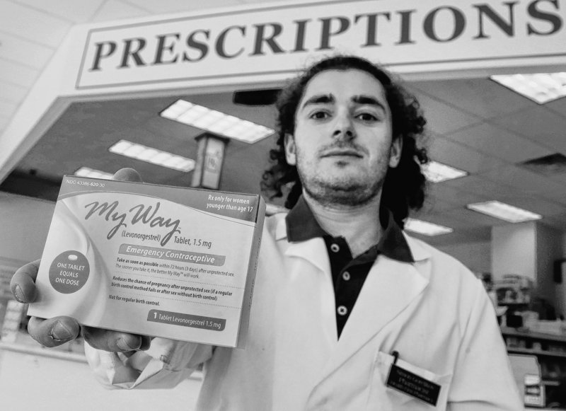 Pharmacist Simon Gorelikov holds a generic emergency contraceptive at the Health First Pharmacy in Boston.