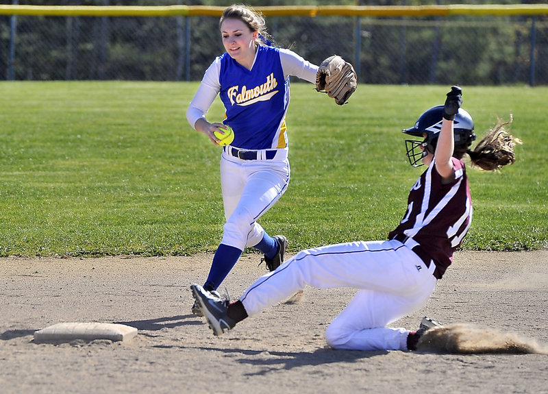 Jayde Bazinet of Falmouth races to second base in an attempt for a forceout Saturday, but a sliding Sarah Felkel of Greely beats her to the bag during their Western Maine Conference softball game. Falmouth came away with an 8-7 victory.