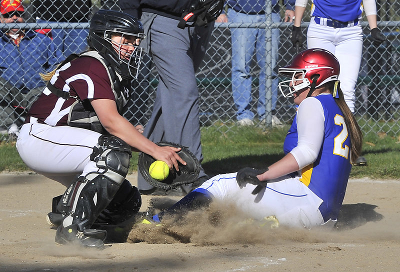 Elizabeth Walker of Falmouth slides in to score as Greely catcher Audrey Mann tries to control the ball. Walker’s triple in the sixth inning was the game-winner.