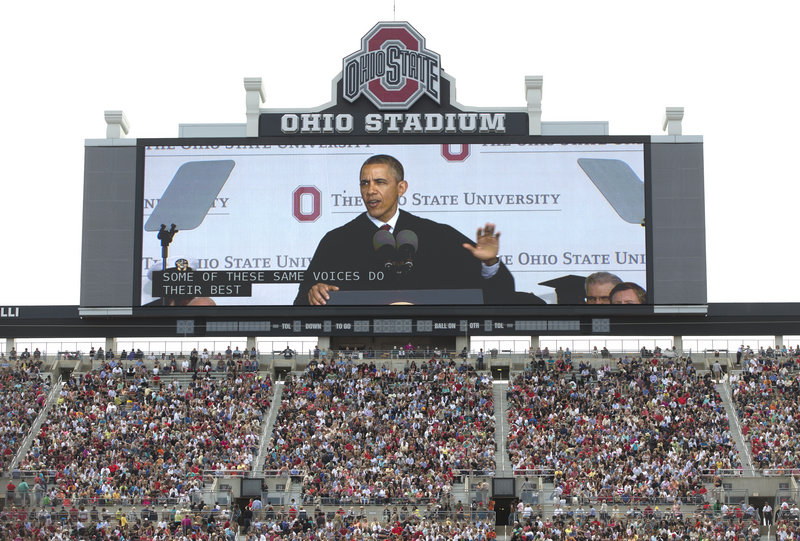President Obama is seen on a video screen as he speaks during the Ohio State University spring commencement in the Ohio Stadium on Sunday in Columbus, Ohio. Obama encouraged graduates to participate in public life.