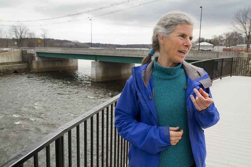 RiverWalk Coalition Director Alix Hopkins talks about her organization’s plans while standing on a scenic overlook that gives views of the Saco River on the Biddeford side.