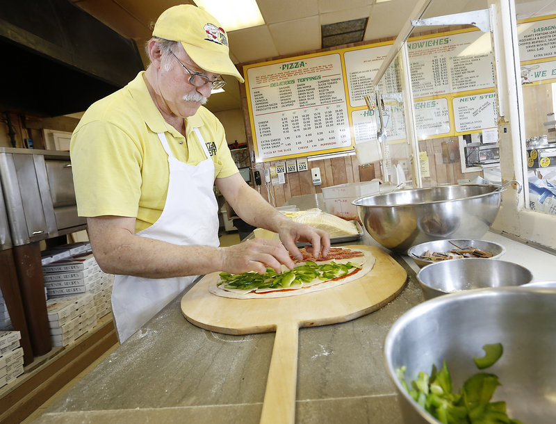 Joe Poliquin creates a pie at the Pizza Joint in South Portland.