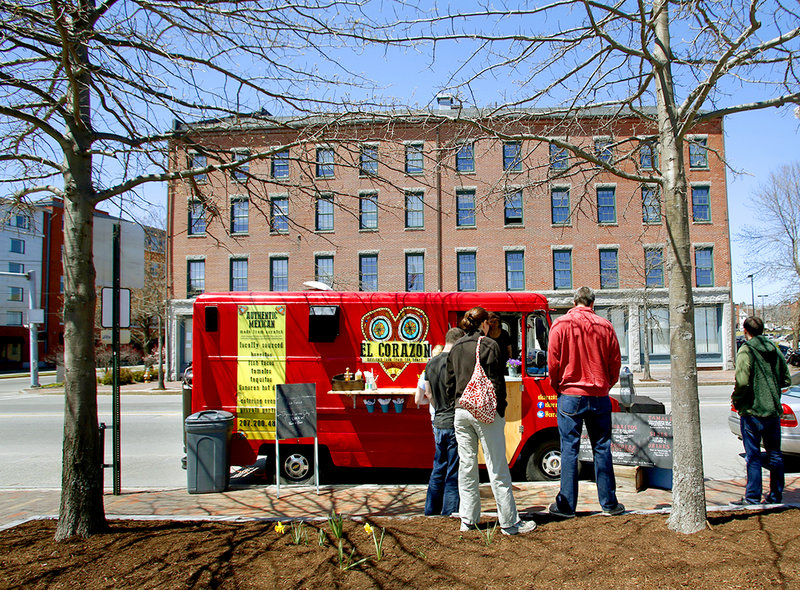 Customers queue up at El Corazon food truck, which was parked on Commercial Street in Portland on Sunday.