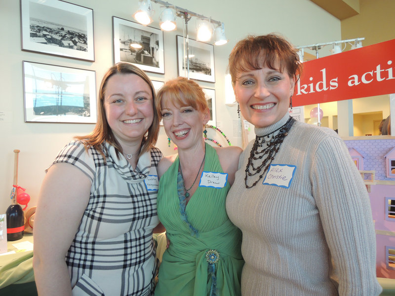 Gabby Heggeman of Standish, left, an employee at the Children’s Museum & Theatre of Maine, and volunteers Kelley Drew and Alexandra Christie, both of Portland, work at the Kids Activities table at the May 3 benefit at the Ocean Gateway in Portland.