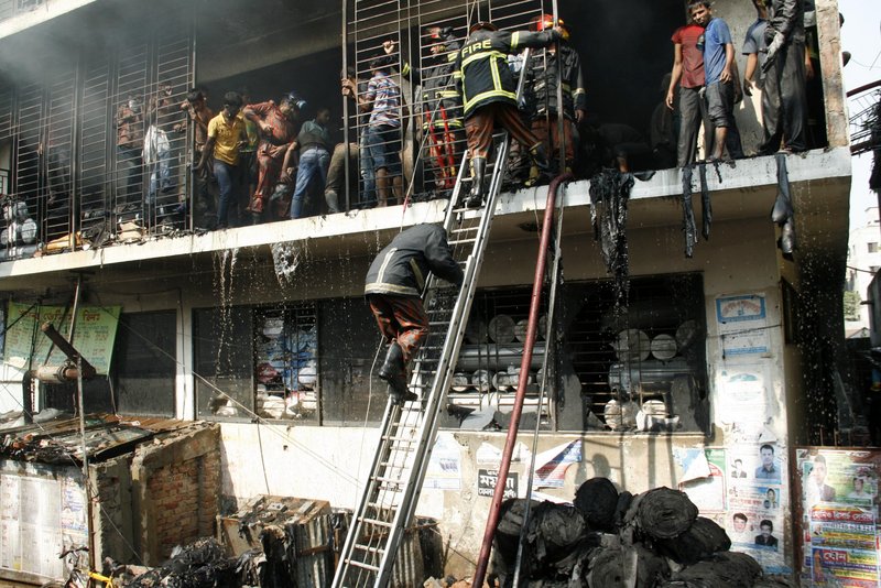 Firefighters try to douse a garment factory fire in Dhaka, Bangladesh, last year. After a series of fatal incidents in the industry there, experts say businesses that sell clothing need to help eliminate work hazards to protect their images.