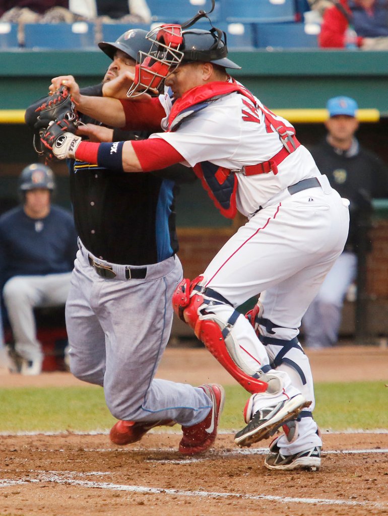 Portland catcher Christian Vazquez holds onto the ball while tagging Reading’s Jim Murphy to end the fourth inning of Monday’s game in Portland, won by the Sea Dogs.
