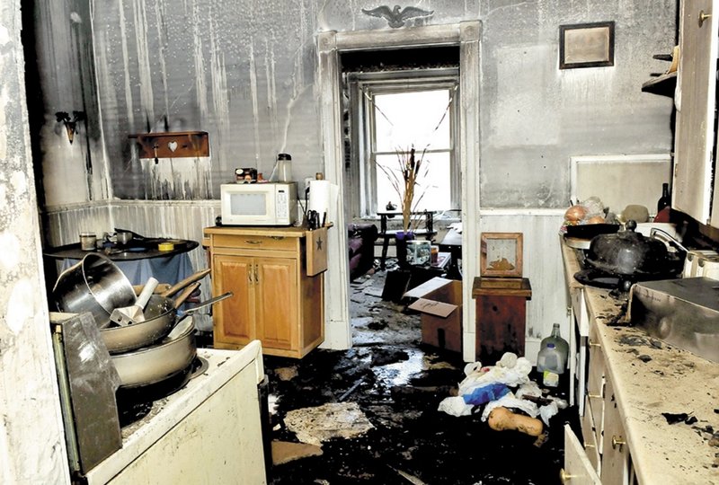 The fire that broke out Friday on Main Street in downtown Waterville destroyed one building and damaged two others. The kitchen of this second-floor apartment sustained both fire and water damage. State investigators have not been able to determine the cause of the fire.