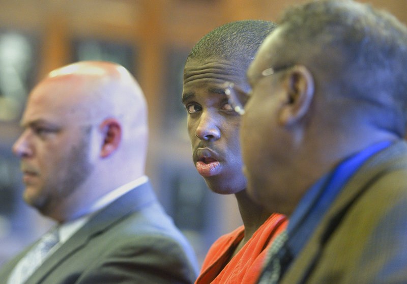 Mohammed Mukhtar, center, who was convicted of raping a Portland woman, confers with a Somali interpreter during his sentencing hearing Tuesday in a Portland courtroom.