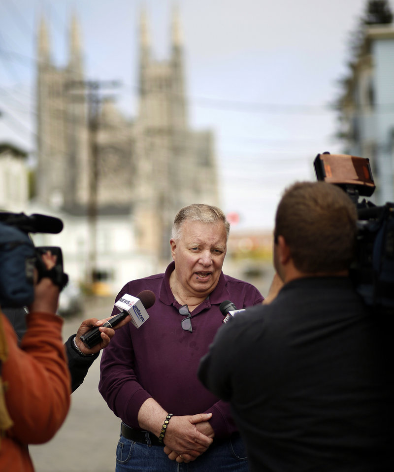 Lewiston Mayor Robert Macdonald talks to the media Tuesday on Bartlett Street. Local residents and businesses have helped fire victims by donating volunteer time and goods.