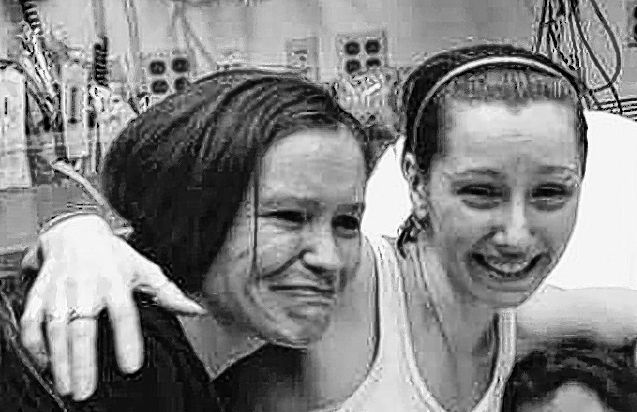 Amanda Berry, right, hugs her sister, Beth Serrano, after being reunited in a hospital Monday. Berry and two other women were found after being missing for about a decade.