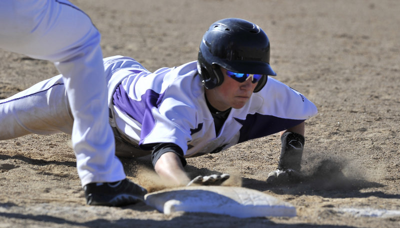 Nick Bevilacqua of Deering makes it back to first base as Biddeford attempts to pick him off. Bevilacqua later singled during a two-run seventh inning that tied the game before Biddeford won it.