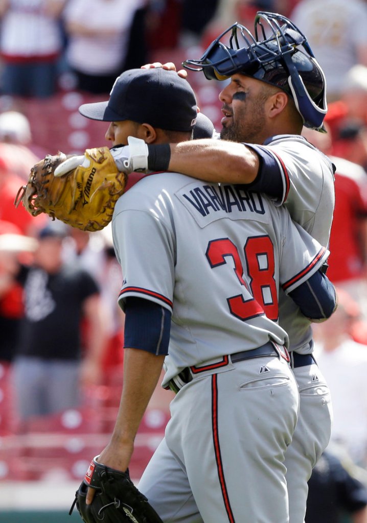 Atlanta catcher Gerald Laird congratulates relief pitcher Anthony Varvaro after the Braves beat the Cincinnati Reds 7-2 on Wednesday.