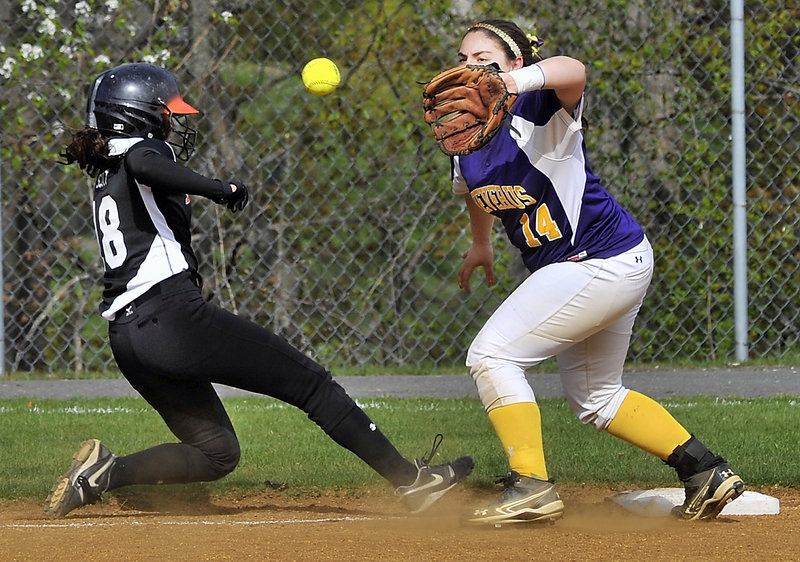 Sara Scott of Biddeford slides safely back to third base Wednesday as Katie Roy of Cheverus takes the throw from first base during their SMAA softball game at Cheverus High. Biddeford improved to 6-3 with a 5-3 victory.
