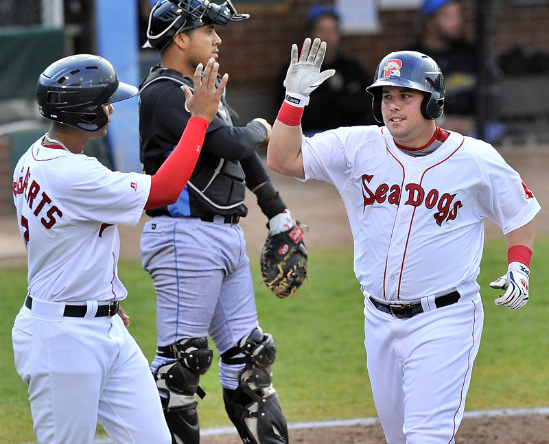 J.C. Linares of the Portland Sea Dogs, right, is welcomed by Xander Bogaerts after both scored in the fifth inning Wednesday – all part of a 10-4 win over Reading.