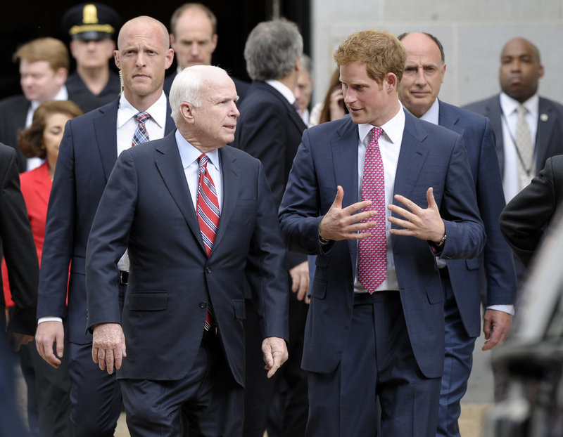 Prince Harry talks with Sen. John McCain, R-Ariz., as they leave the Russell Senate Office Building.