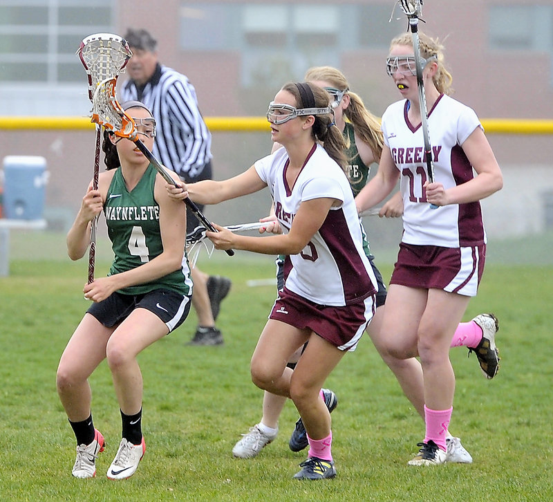 Sofia Canning of Waynflete looks to pass as Eliza McKenney, center, and Meg Finlay of Greely move in to defend.