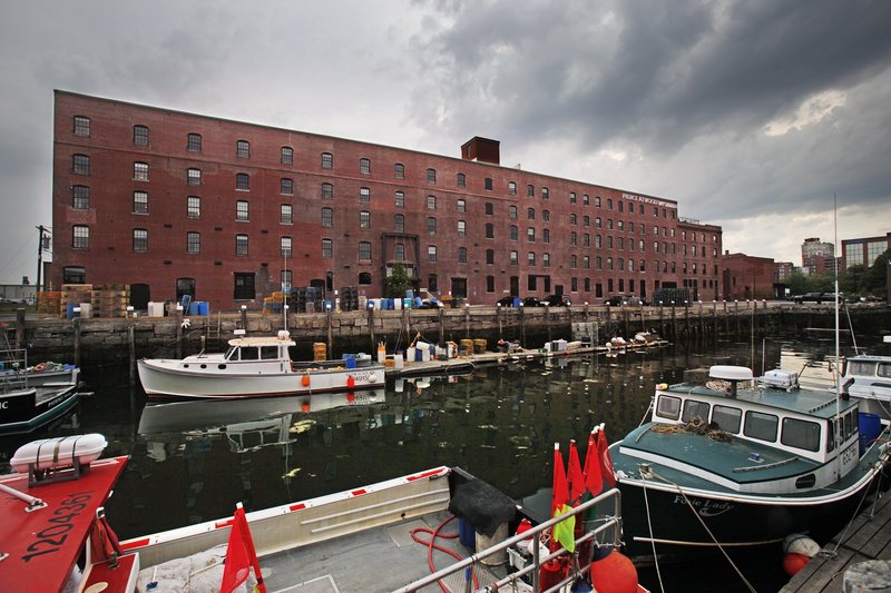 The ground floor of the Merrill’s Wharf building has yet to attract a marine-use tenant nine months after Pierce Atwood moved into the upper floors.