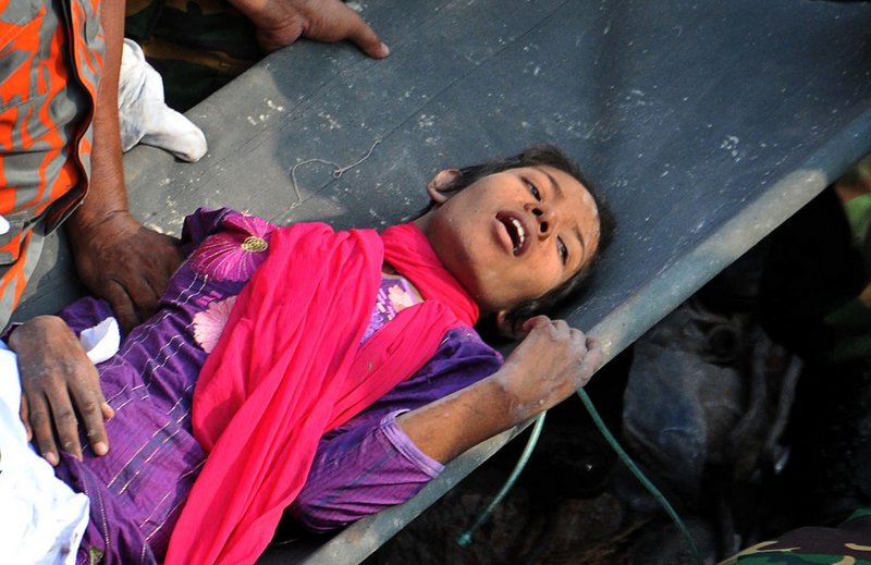 Reshma Begum lies on a stretcher Friday after being pulled from the basement of an eight-story garment factory that collapsed April 24 in Savar, near Dhaka, Bangladesh, killing more than 1,000 people. The rescue was broadcast on TV across the country.