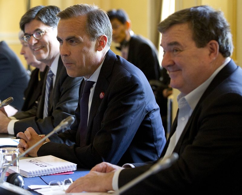 Mark Carney, governor of the Bank of Canada, is flanked by U.S. Treasury Secretary Jacob Lew, left, and Canadian Finance Minister Jim Flaherty at the start of the G7 finance ministers and central bank governors meeting.