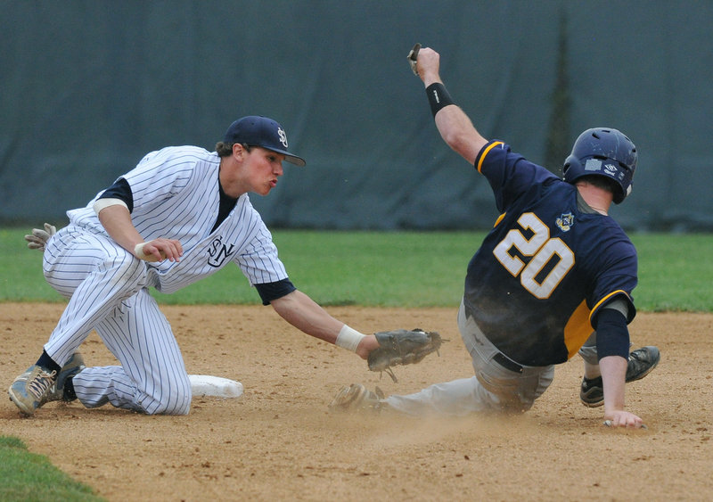 Sam Dexter, the University of Southern Maine shortstop, puts the tag on Corey Allison of UMass-Dartmouth, who was nabbed at second after being picked off first base in the second inning Saturday. USM won 4-2 and will learn Sunday who and where it will play in the NCAA regionals.