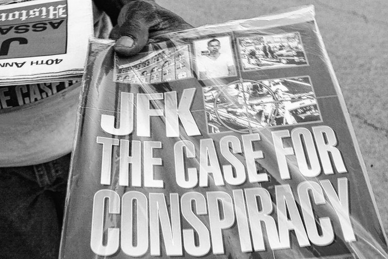 A vendor holds a publication titled “JFK The Case For Conspiracy” in Dallas in 2003.