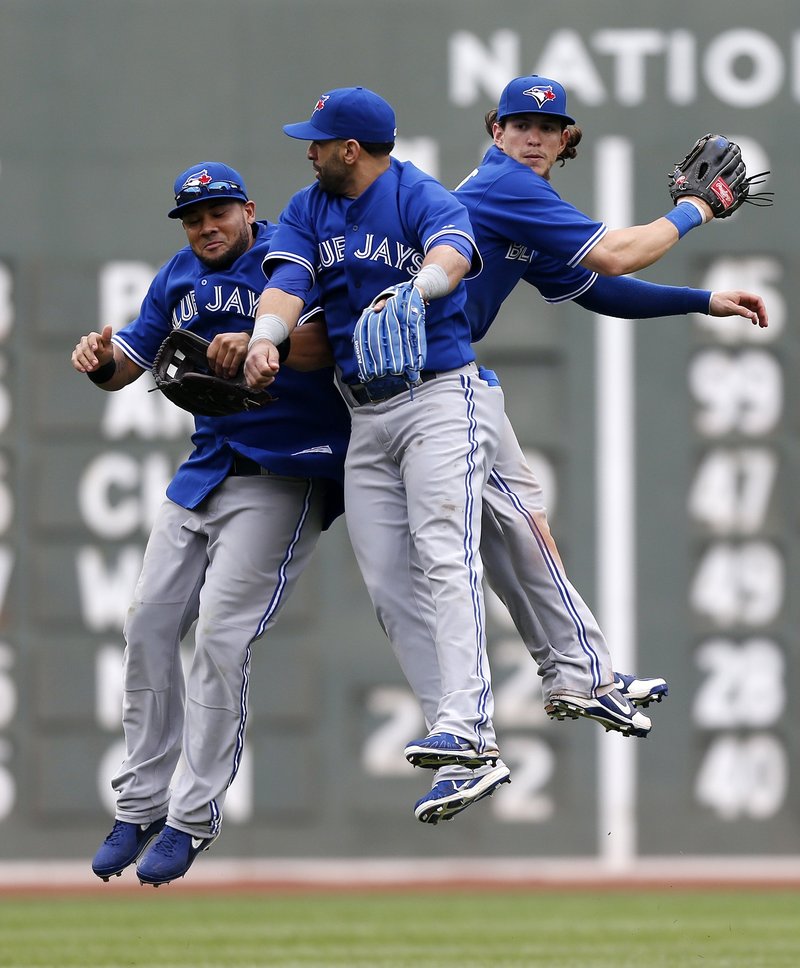 It’s a rare celebration for Toronto’s Melky Cabrera, Jose Bautista and Colby Rasmus, who whoop it up after the Blue Jays held on to beat the suddenly slumping Red Sox.