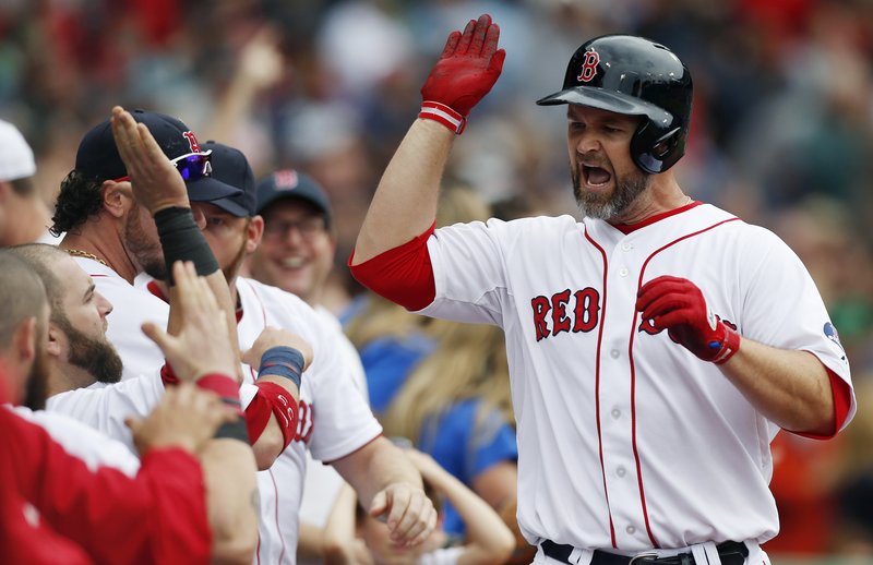 Boston’s David Ross celebrates after scoring the tying run in the eighth inning, but the good times ended in the ninth when the Blue Jays scored the winning run.