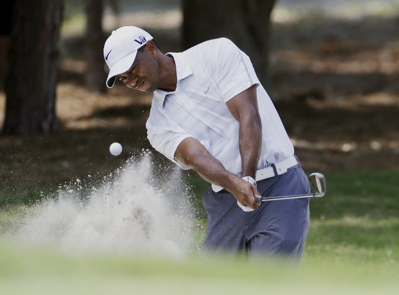 Tiger Woods hits from a sand trap Saturday on the second hole – the hole that caused a problem when Sergio Garcia felt he was distracted when Woods selected a club.