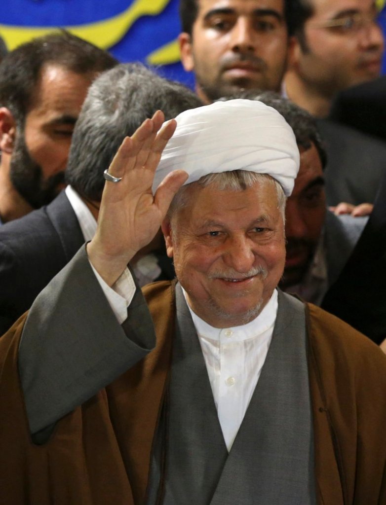 Former President Akbar Hashemi Rafsanjani waves as he registers his candidacy for the presidential election.