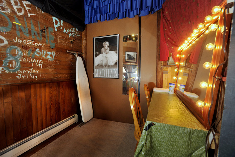 The backstage dressing room’s walls are signed by those who have entertained audiences in the past, and an ironing board stands at the ready for use by current performers.