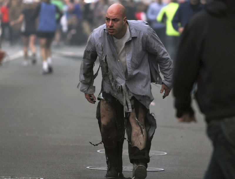 The image shows James "Bim" Costello staggering away from the Boston Marathon bombings, his body singed black by the explosions.